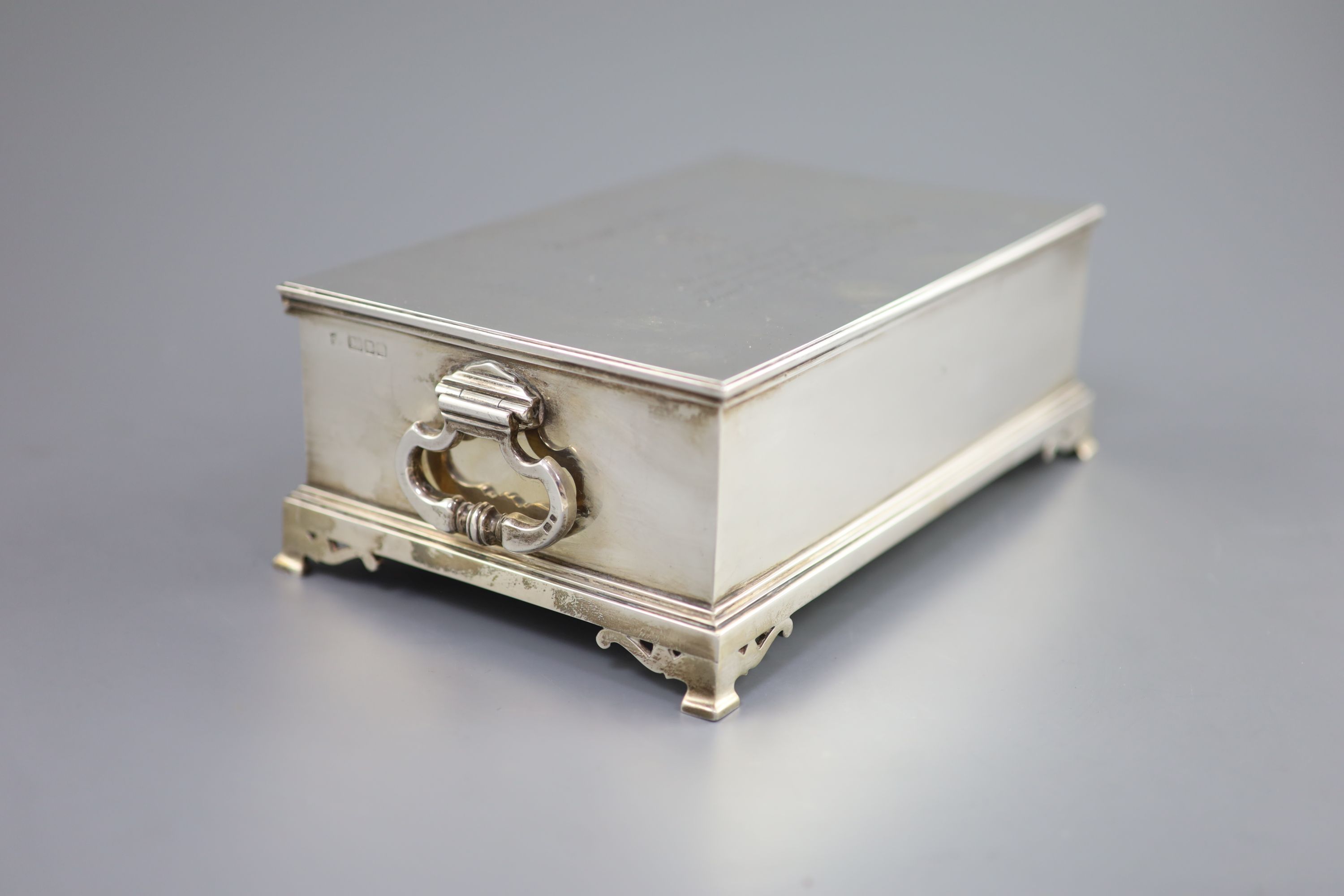 A George VI silver mounted two handled rectangular cigar box, by William Comyns & Sons Ltd, with engraved inscription relating to the Freedom of the Borough of Hove, awarded to Alexander Henry Clarke Esq.